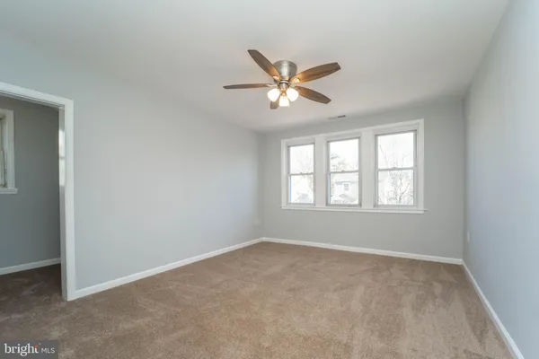 a view of room with a ceiling fan and window