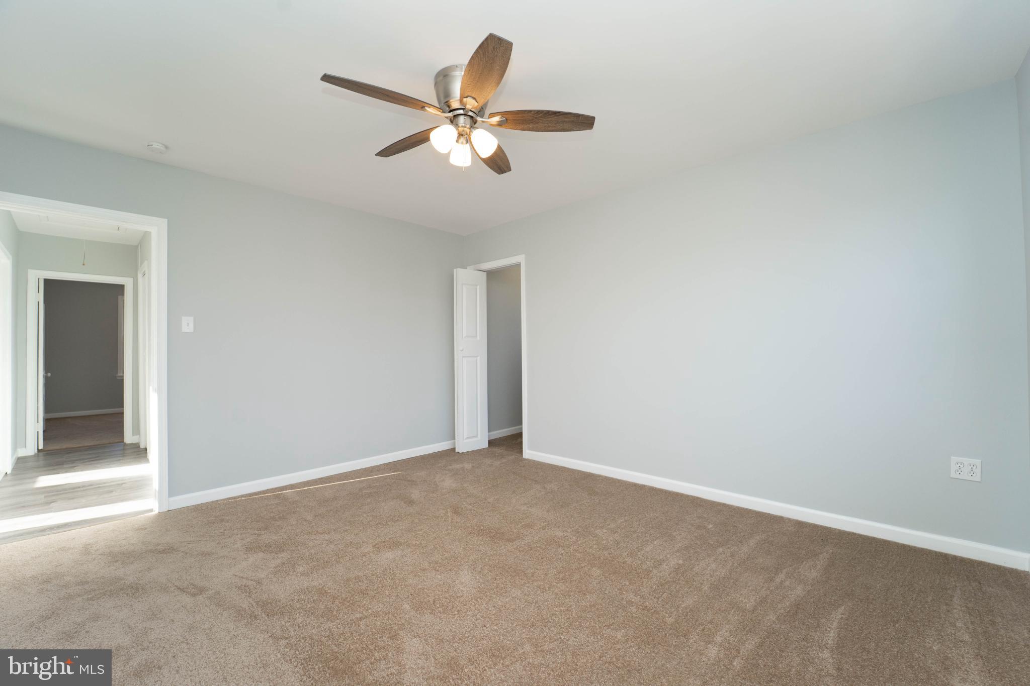 5312 Catalpha Road Baltimore, MD 21214 - Photo 32 of 41 a view of an empty room with a chandelier fan