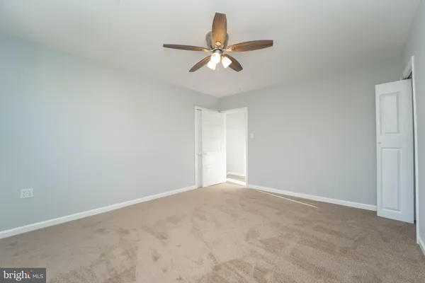 a view of room with window and ceiling fan