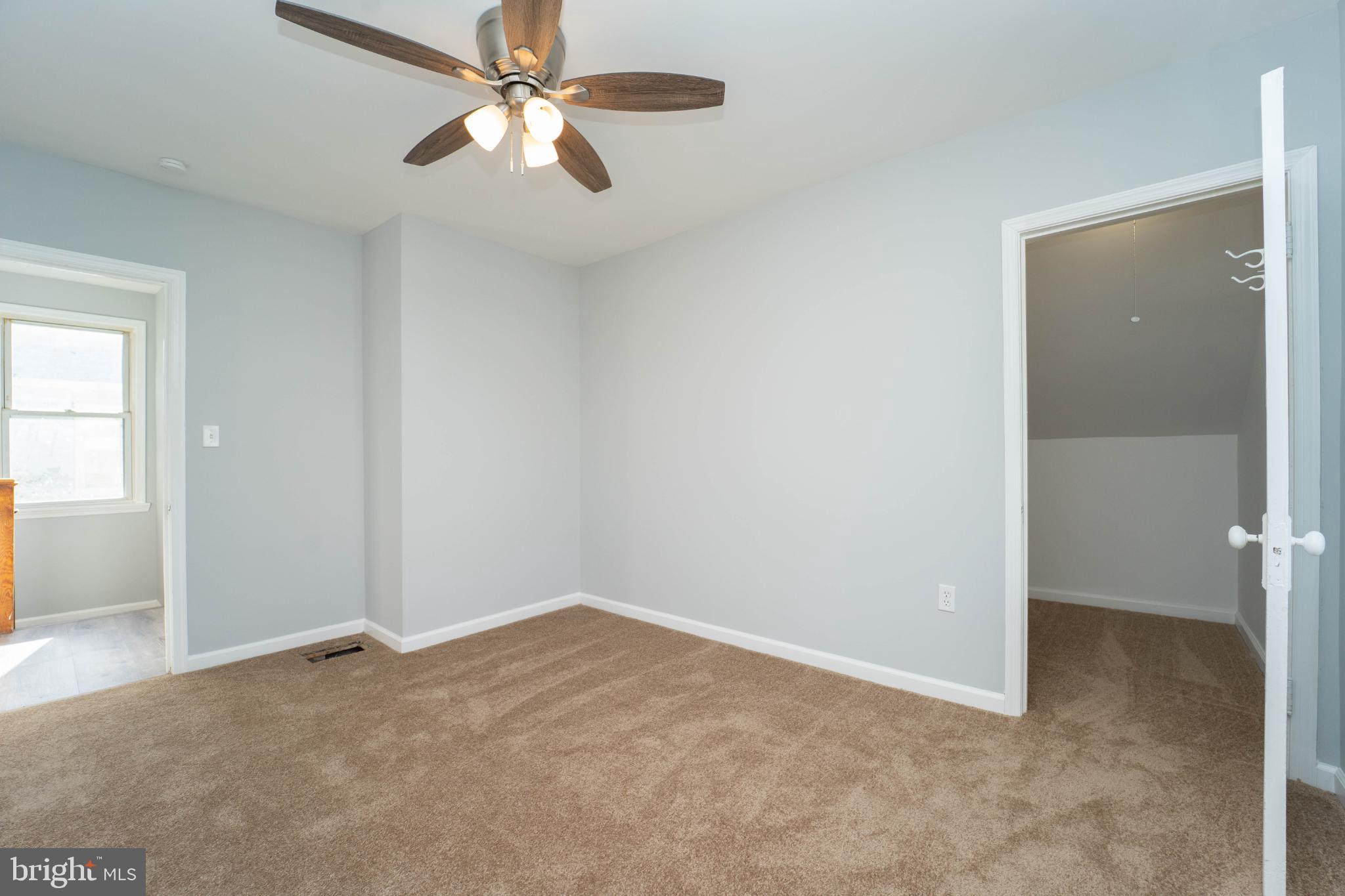 5312 Catalpha Road Baltimore, MD 21214 - Photo 38 of 41 a view of a room with a ceiling fan and a window