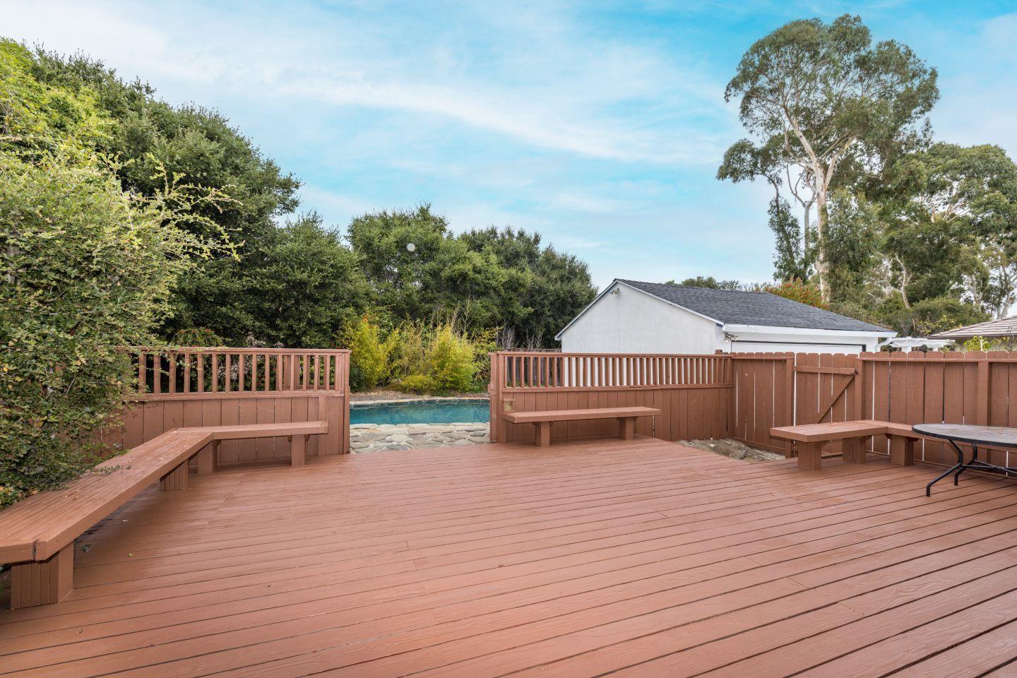 930 Sequoia Avenue Millbrae, CA 94030 - Photo 5 of 10 a view of a deck with wooden floor and fence with a large tree