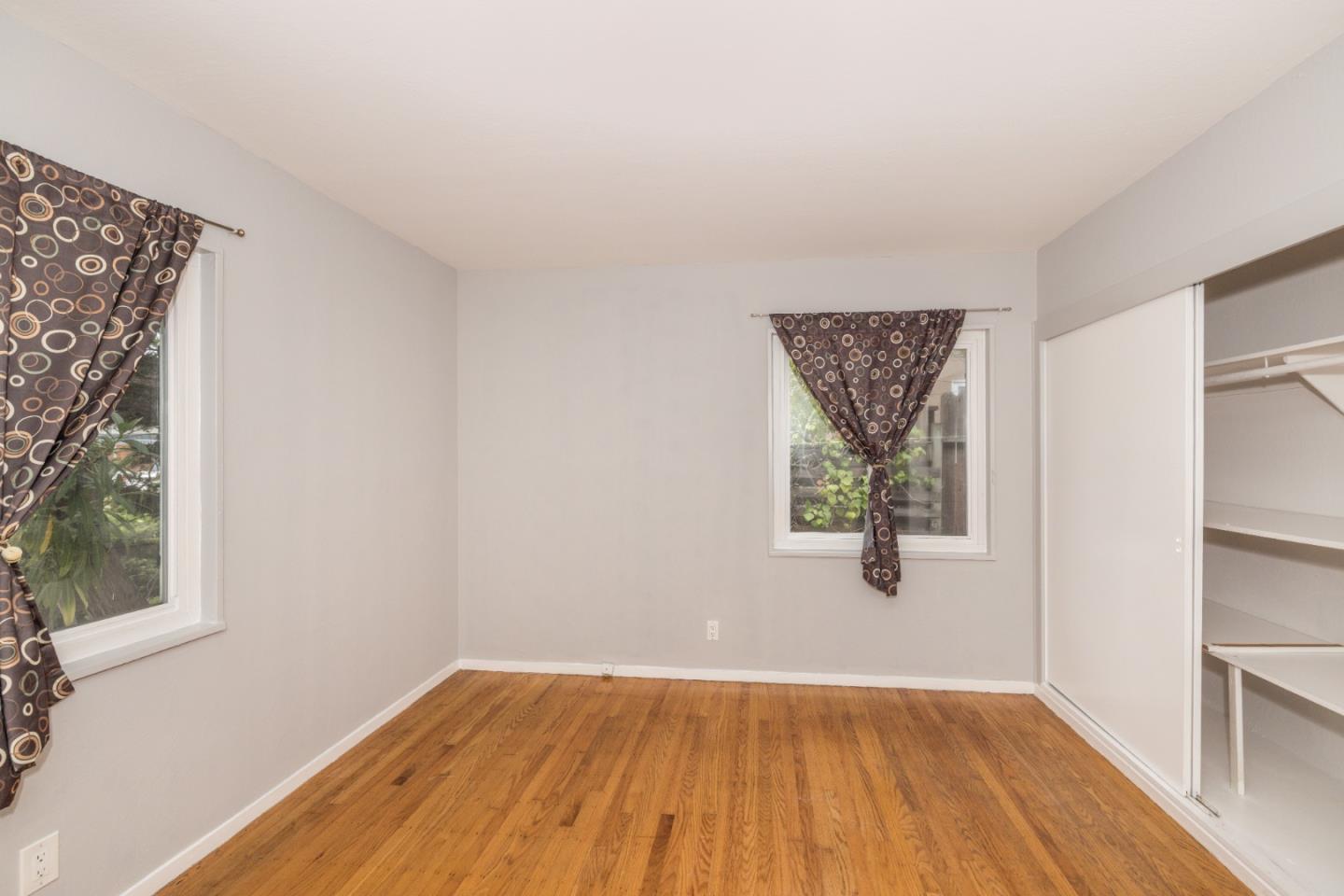 930 Sequoia Avenue Millbrae, CA 94030 - Photo 8 of 10 an empty room with wooden floor and windows