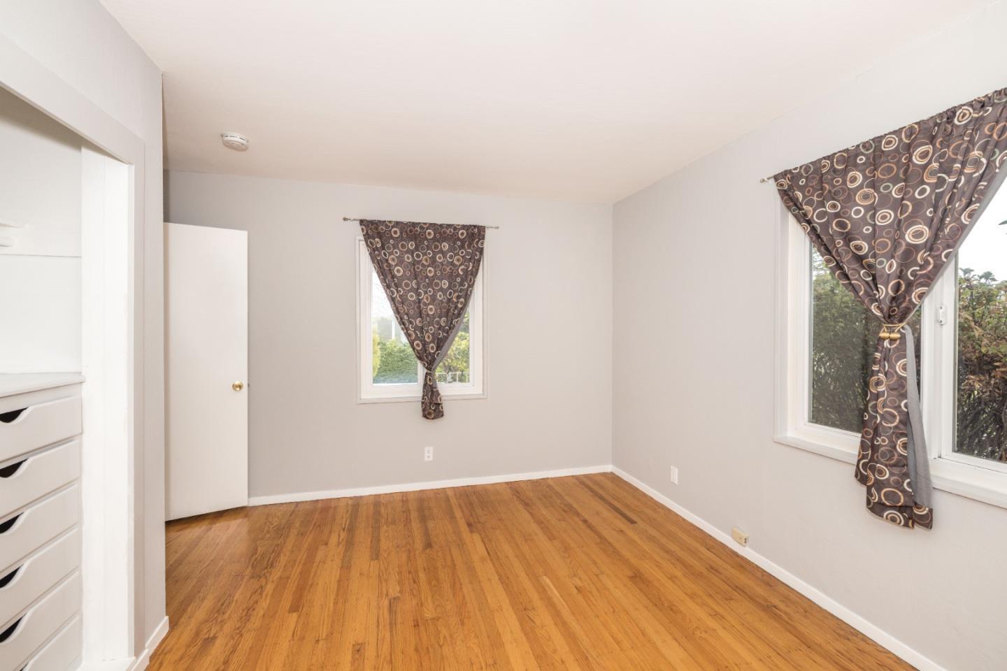 930 Sequoia Avenue Millbrae, CA 94030 - Photo 9 of 10 an empty room with wooden floor and windows