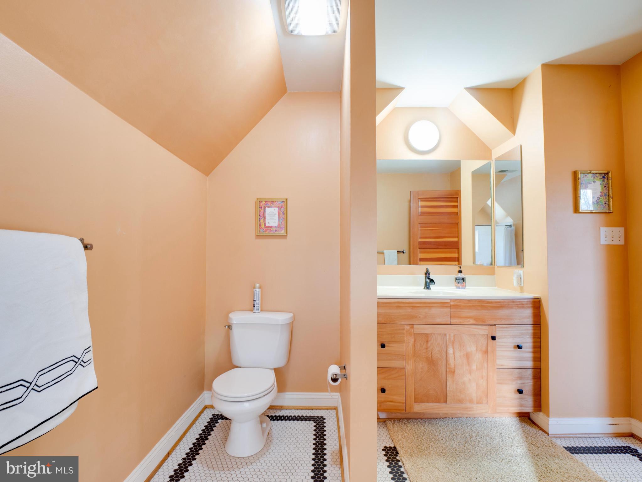 6306 Valley Road Bethesda, MD 20817 - Photo 46 of 74 a bathroom with a granite countertop toilet sink and mirror