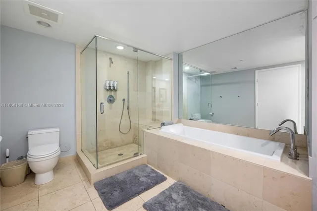 a spacious bathroom with a granite countertop sink a toilet and shower