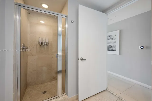 a bathroom with a glass shower door