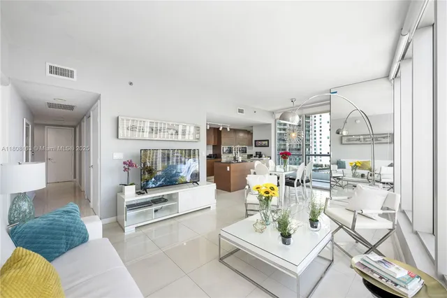 a living room with furniture and a floor to ceiling window