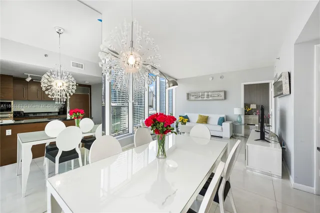 a dining room with furniture and chandelier