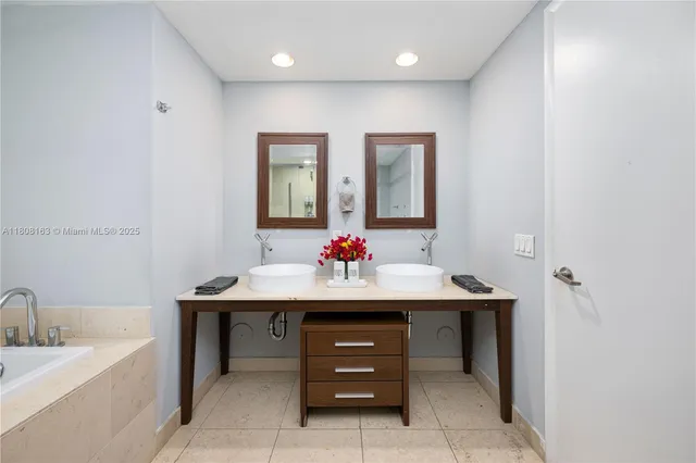 a bathroom with a sink a mirror and a bathtub