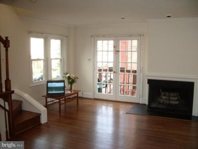539 3rd Street Northeast Washington, DC 20002 - Photo 12 of 29 a living room with furniture wooden floor and a fireplace