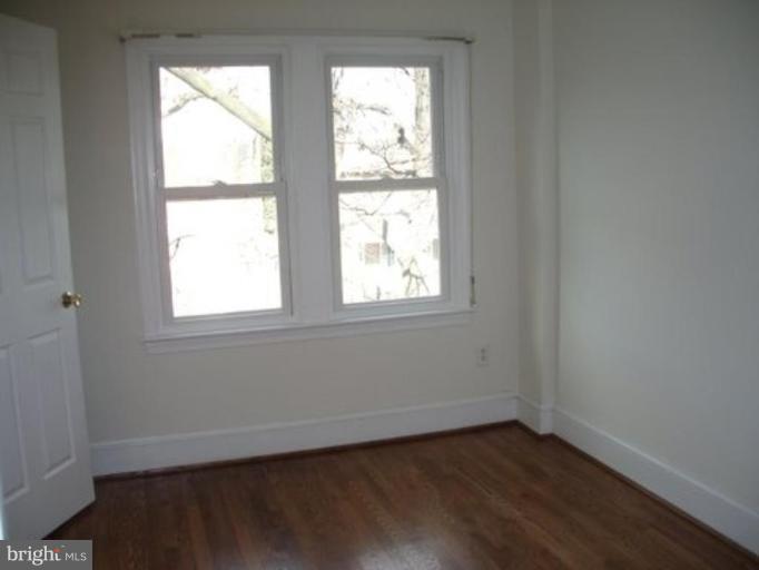 539 3rd Street Northeast Washington, DC 20002 - Photo 26 of 29 an empty room with wooden floor and windows