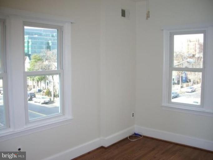 539 3rd Street Northeast Washington, DC 20002 - Photo 28 of 29 an empty room with wooden floor and windows
