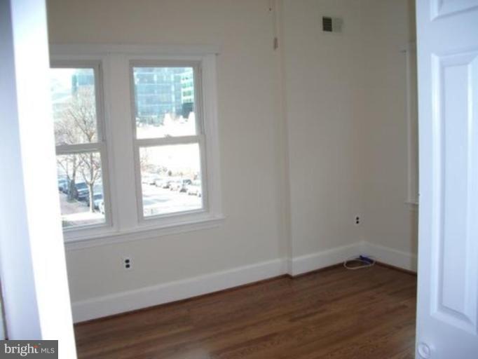 539 3rd Street Northeast Washington, DC 20002 - Photo 29 of 29 an empty room with wooden floor and windows