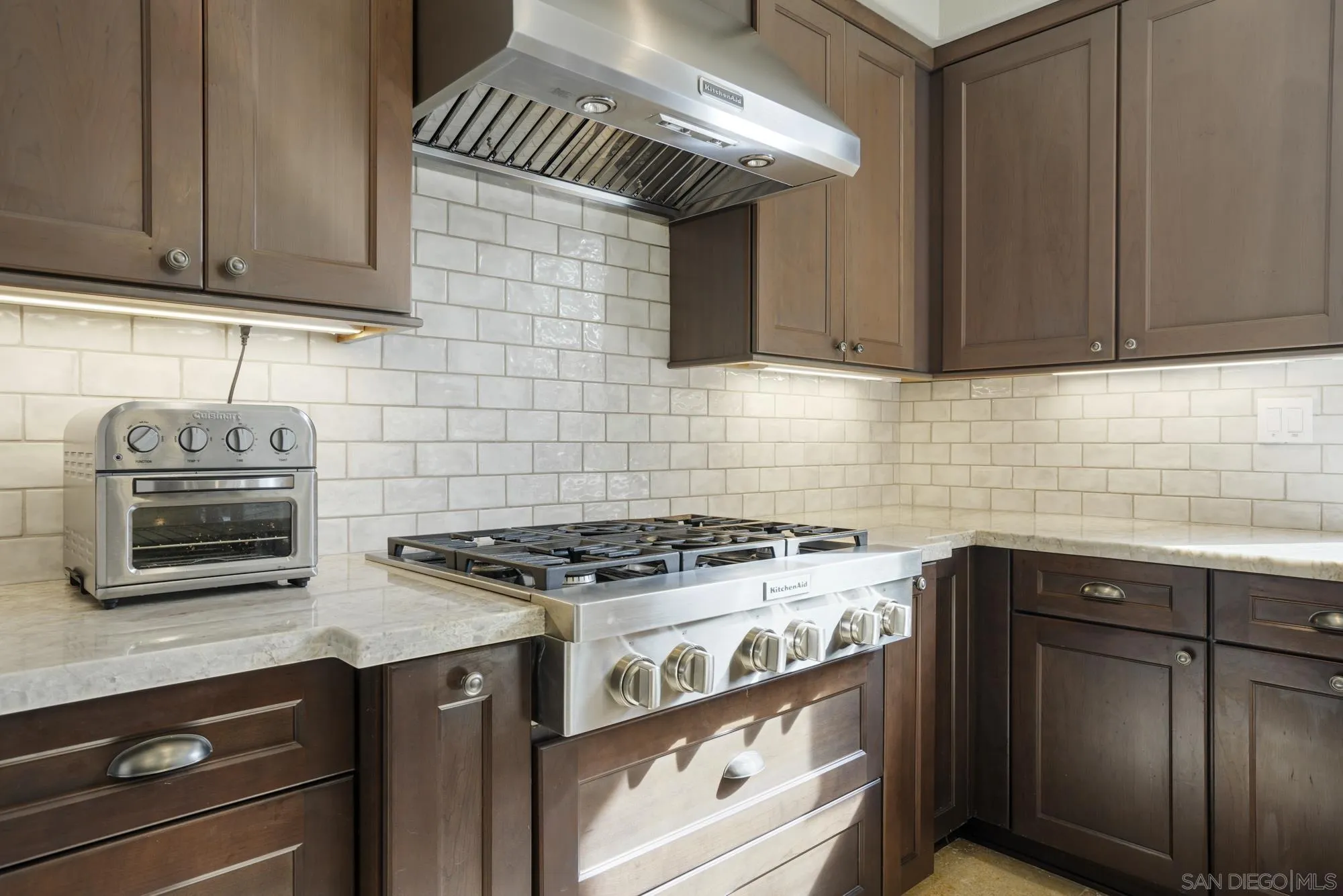 684 Cypress Hills Drive Encinitas, CA 92024 - Photo 11 of 43 a kitchen with stainless steel appliances granite countertop a stove and a sink