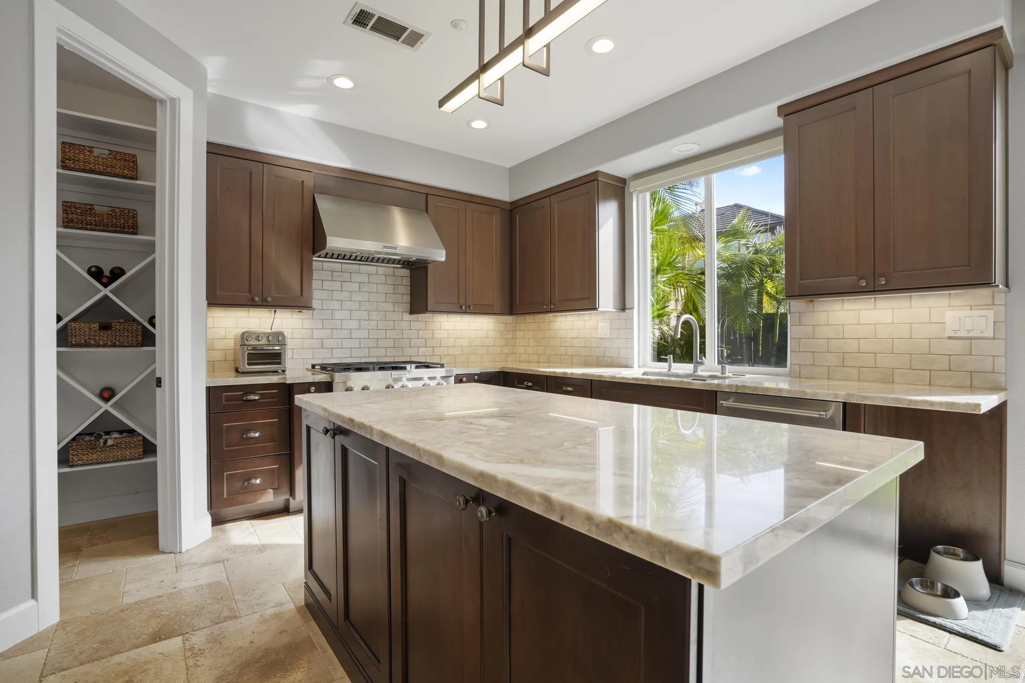 684 Cypress Hills Drive Encinitas, CA 92024 - Photo 15 of 43 a kitchen with a sink a stove and cabinets