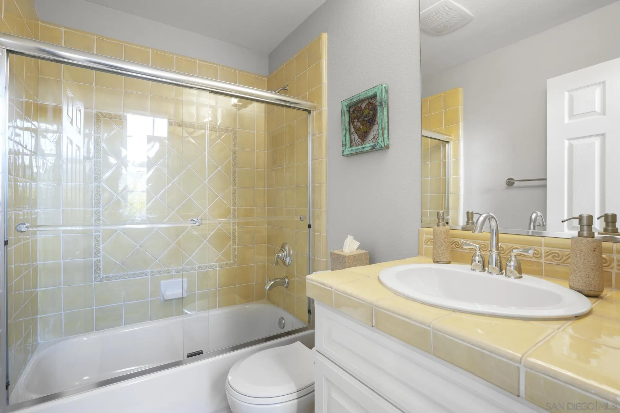 684 Cypress Hills Drive Encinitas, CA 92024 - Photo 28 of 43 a bathroom with a sink and a mirror