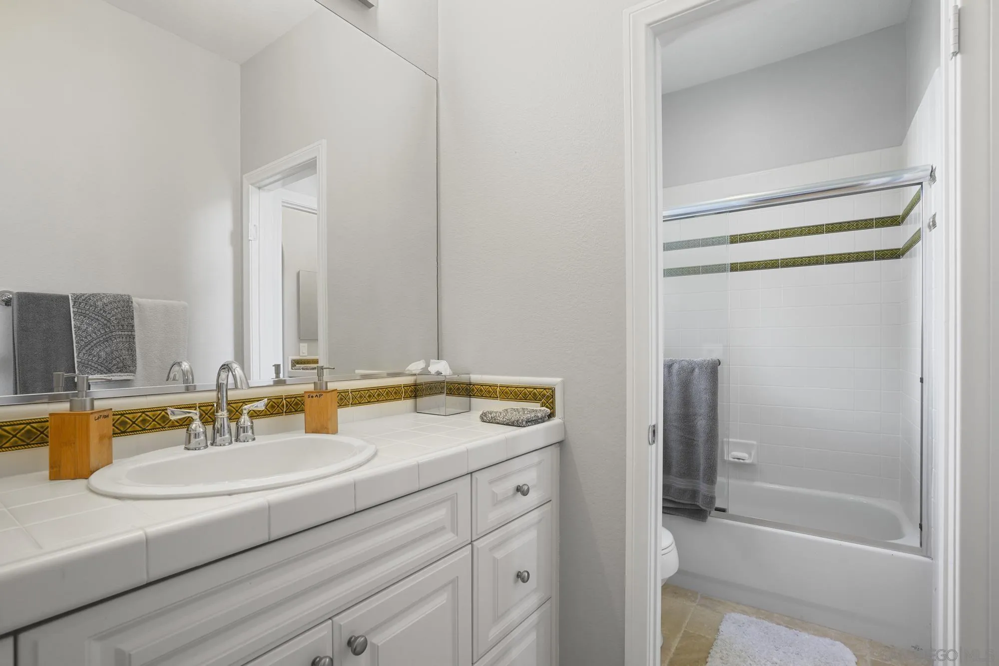 684 Cypress Hills Drive Encinitas, CA 92024 - Photo 33 of 43 a bathroom with a granite countertop sink and a mirror
