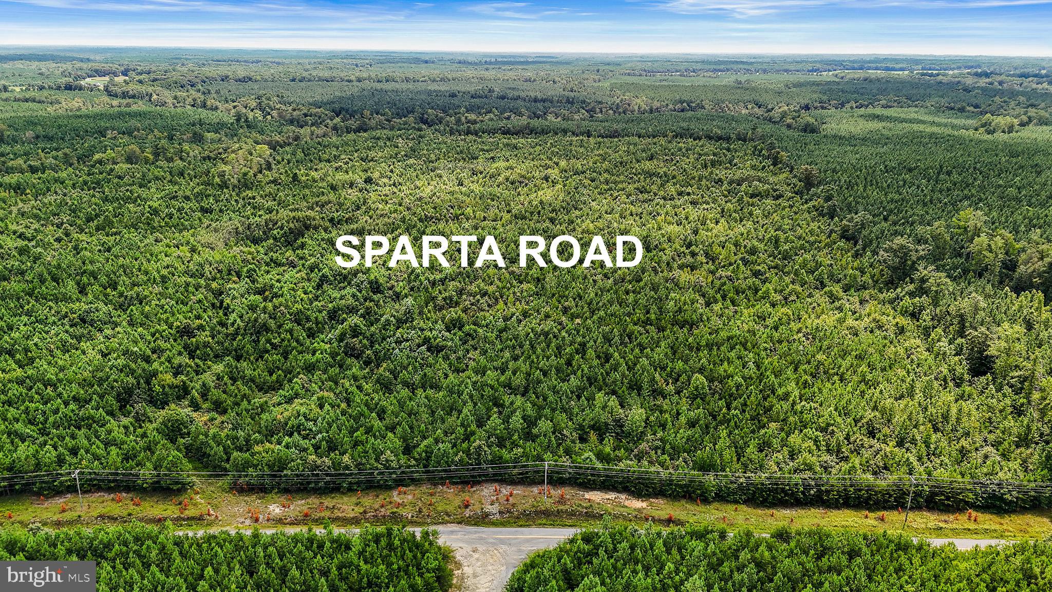 a view of a field with an ocean view
