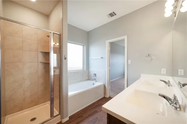 a bathroom with a bathtub and a shower