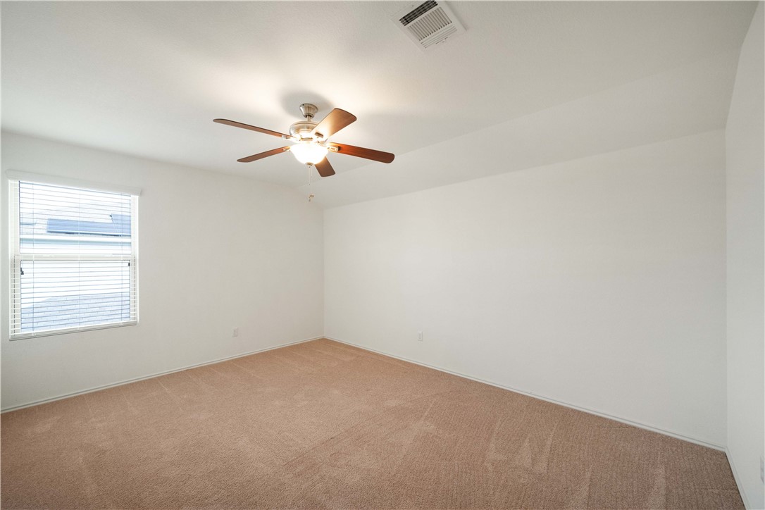 820 Kates Way Hutto, TX 78634 - Photo 18 of 30 an empty room with a window and a fan