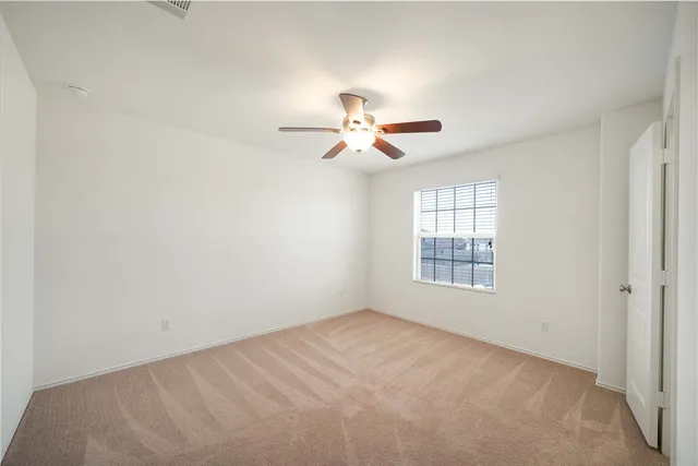 a view of a room with a window and a fan