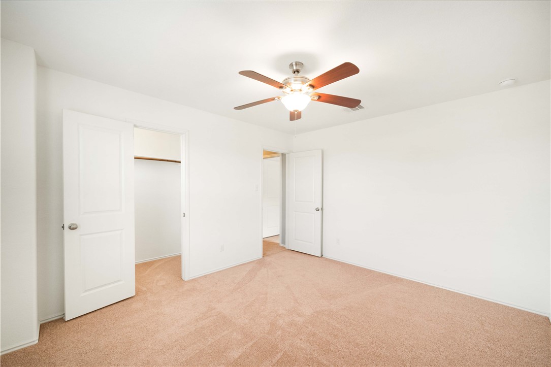 820 Kates Way Hutto, TX 78634 - Photo 24 of 30 an empty room with closet and fan