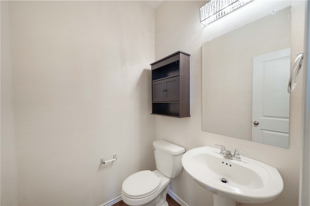 820 Kates Way Hutto, TX 78634 - Photo 5 of 30 a bathroom with a toilet a sink and mirror