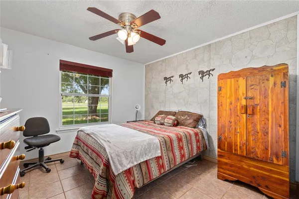 a bedroom with a bed and a chair