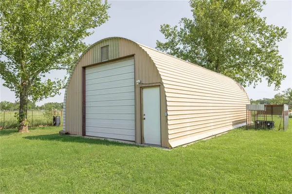 a view of a backyard with wooden fence