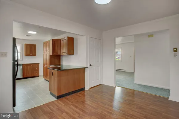 a kitchen with stainless steel appliances granite countertop a sink refrigerator and microwave