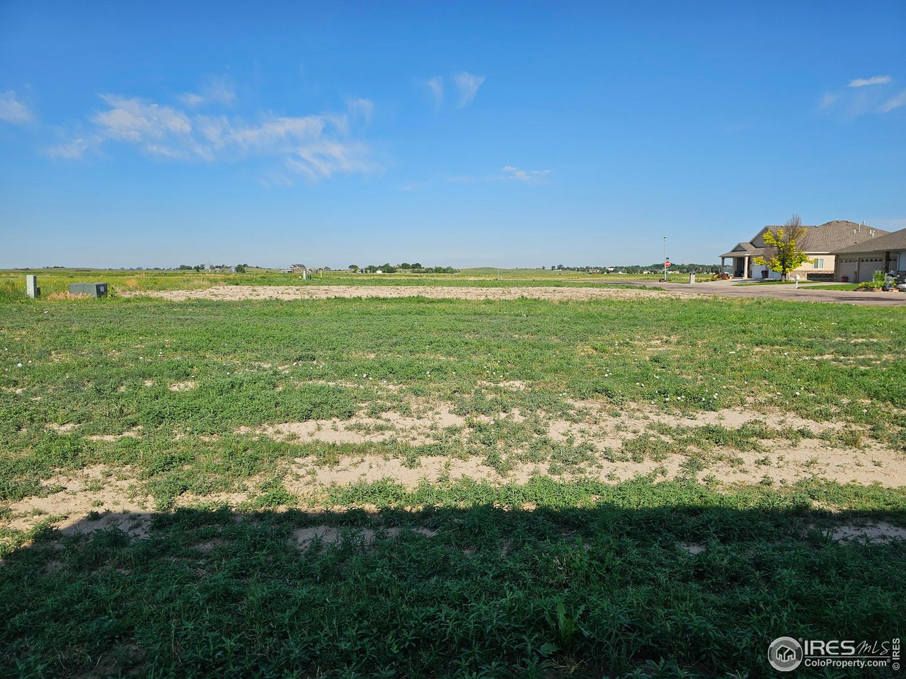 View from the sidewalk on the east edge of the property looking west