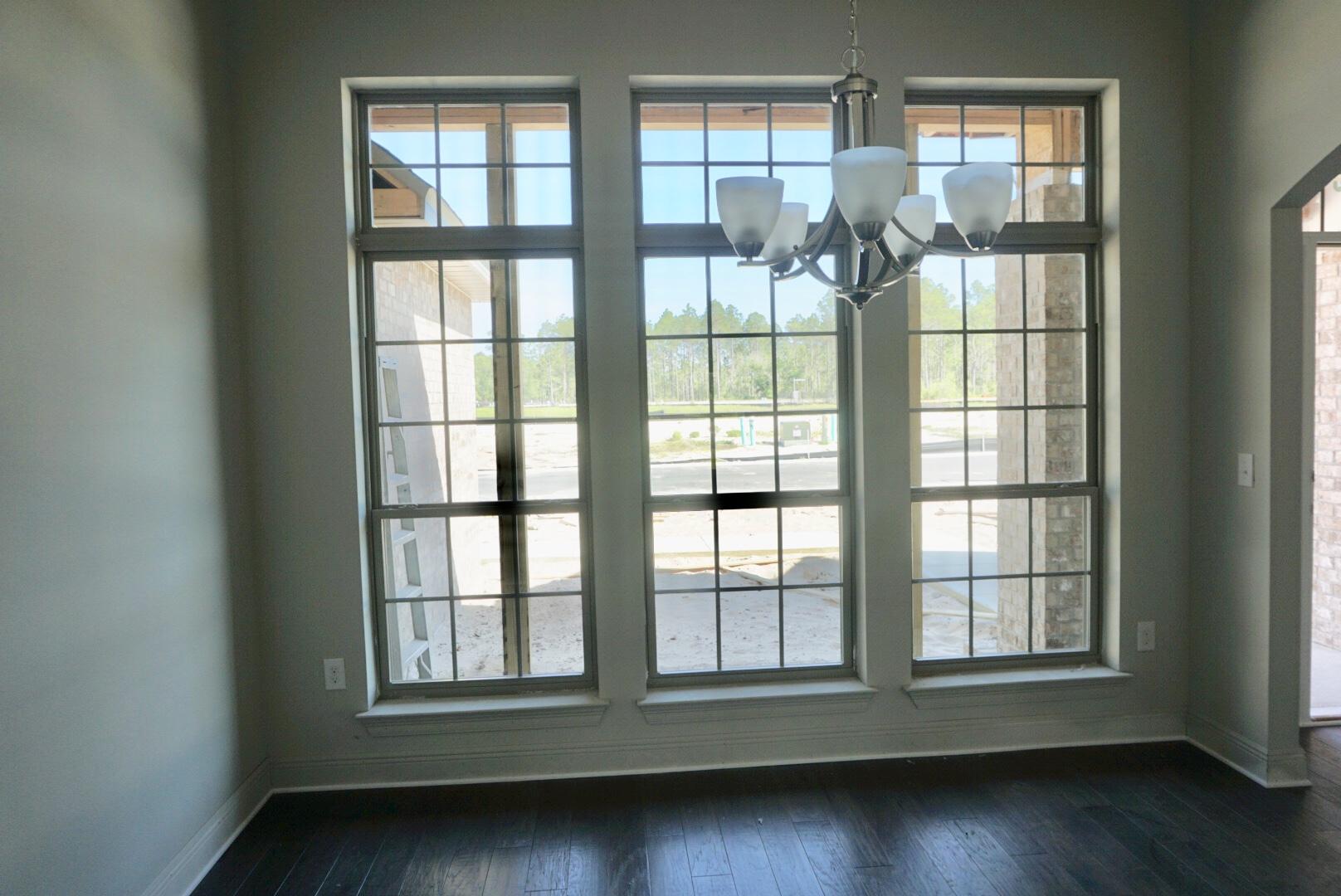 73 Wayne Trail Santa Rosa Beach, FL 32459 - Photo 2 of 13 an empty room with wooden floor and windows