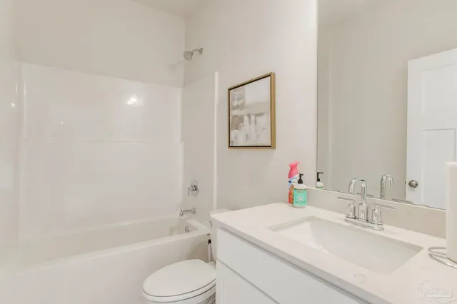 a bathroom with a granite countertop sink toilet tub and shower