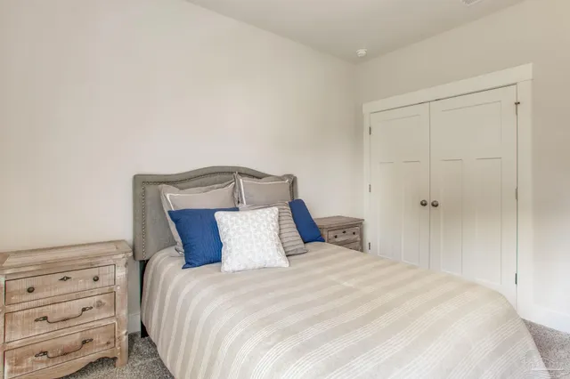 a bedroom with a bed and a night stand