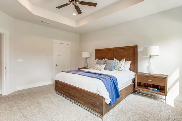 a spacious bedroom with a bed and a chandelier