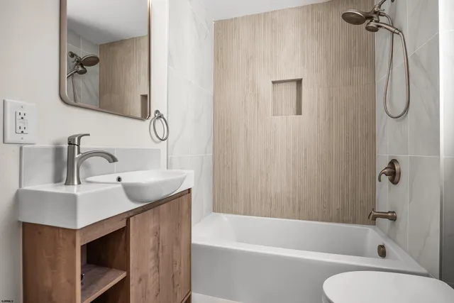 a bathroom with a sink vanity toilet and shower