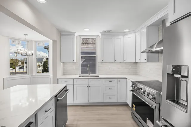 a kitchen with a sink stove and cabinets