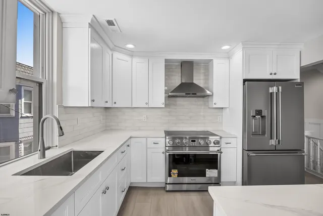 a kitchen with a sink stove and refrigerator
