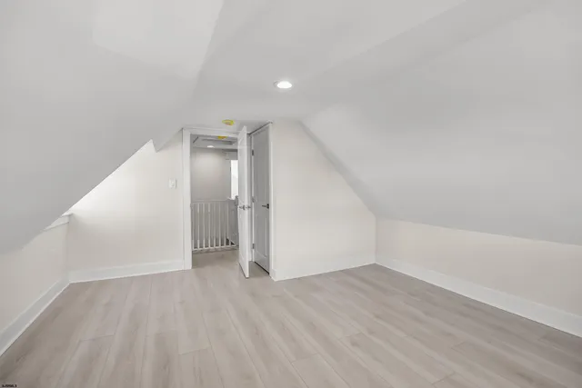 an empty room with wooden floor and white walls