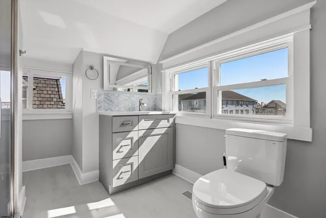 a bathroom with a toilet a sink and a mirror