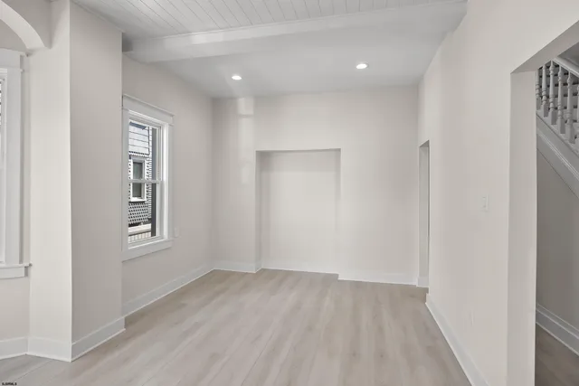 an empty room with windows and closet