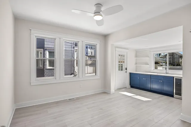a view of an empty room with a kitchen