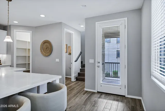 a living room with furniture a window and wooden floor