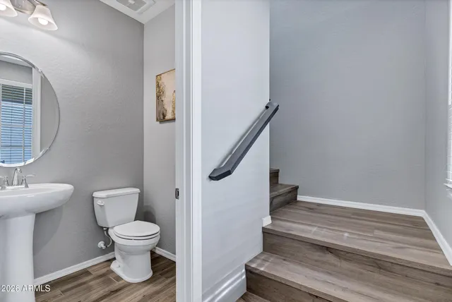 a white toilet sitting next to a bathroom sink