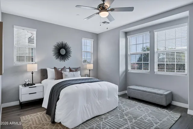 a bedroom with a bed a couch and a window