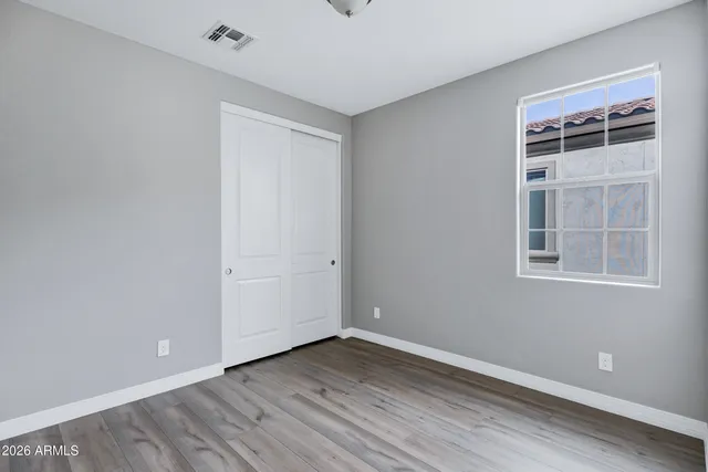 a view of empty room with windows and entryway