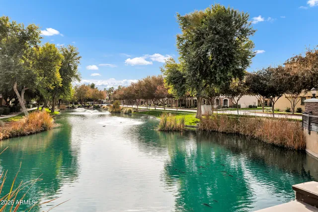 a view of residential house with outdoor space and lake view