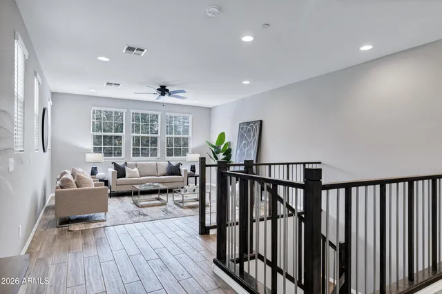a living room with furniture and wooden floor