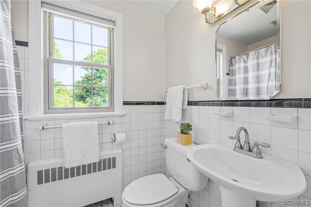 3917 Brook Road Richmond, VA 23227 - Photo 30 of 41 a bathroom with a sink a toilet and a mirror