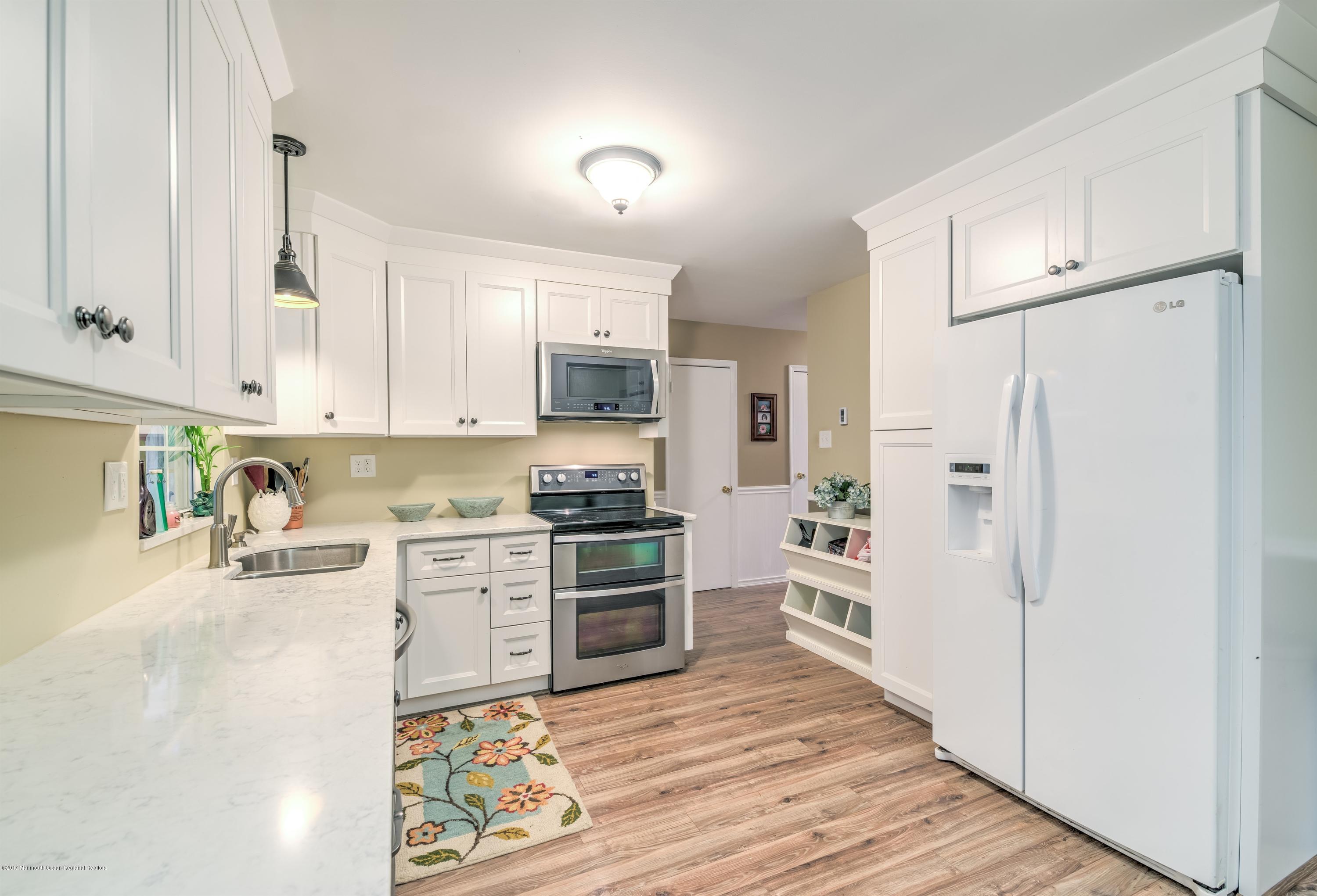 15 Reiner Road Cream Ridge, NJ 08514 - Photo 11 of 27 a kitchen with white cabinets and stainless steel appliances
